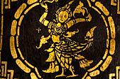 Wat Xieng Thong temple in Luang Prabang, Laos. Detail of the  intricate gold stencilling on black lacquer that decorate the walls of the sim. 